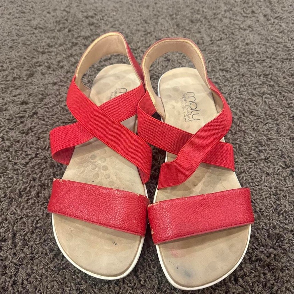 Red leather sandals with white sole